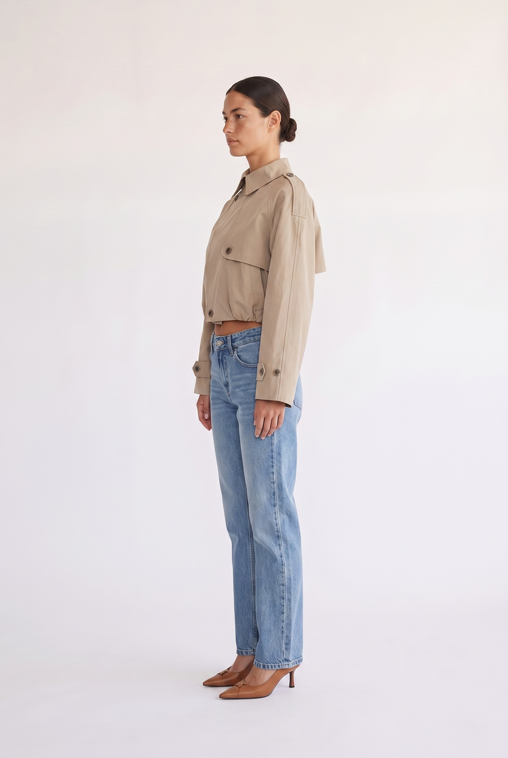 Model styling the Darcy tan cropped double-breasted trench coat
