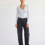Woman wearing the Margaux baby blue deep v henley top, front view