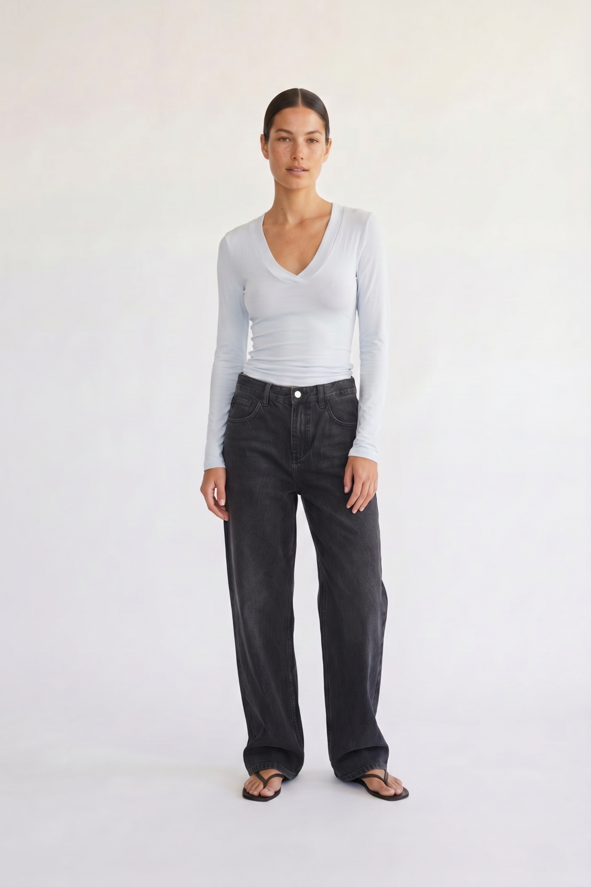 Woman wearing the Margaux baby blue deep v henley top, front view