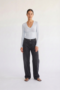 Woman wearing the Margaux baby blue deep v henley top, front view