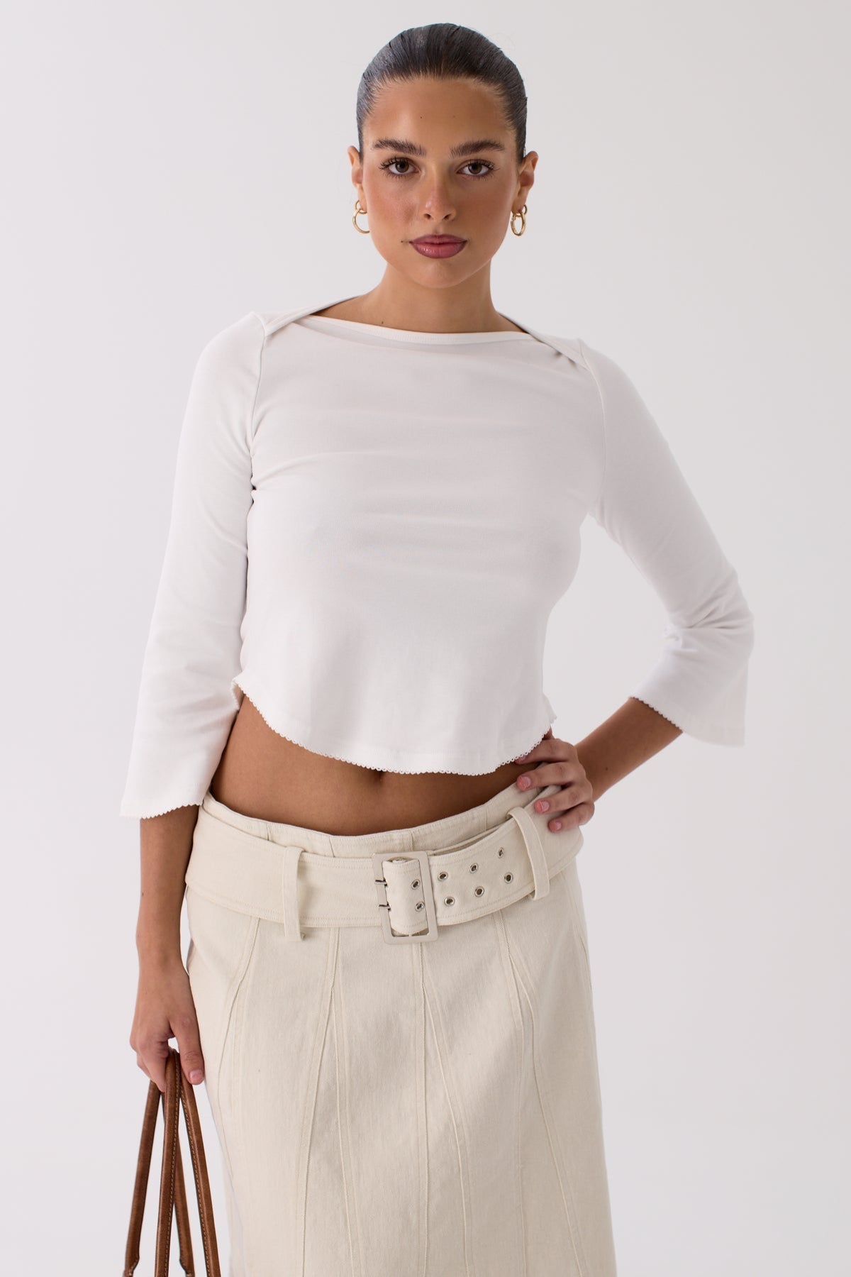 Model wearing the Ryan ivory pleated skirt, full-length