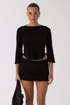 Woman wearing the Lola black top, front view