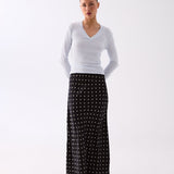 Woman wearing the Inez black polka dot slip skirt, front view