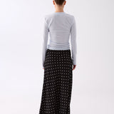 Inez black polka dot slip skirt, side view on a model