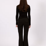 The Tailored Flare Pant in black, three-quarter view